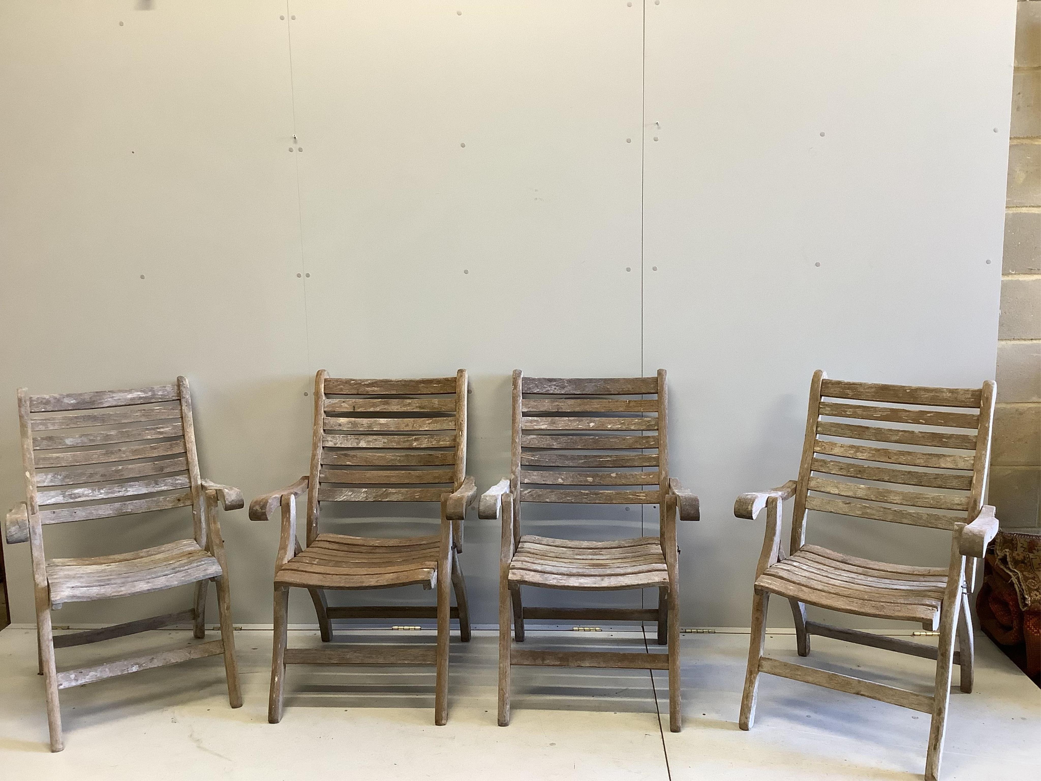 An Alexander Rose circular teak folding garden table with a set of four folding chairs. Condition - table fair, chairs more notably weathered